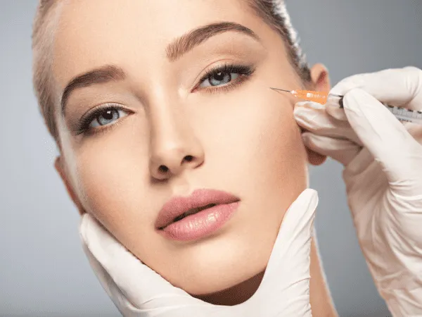 Gorgeous girl taking Botox injection to face | Get Botox at ReLux Medical Spa in Akron, Ohio.